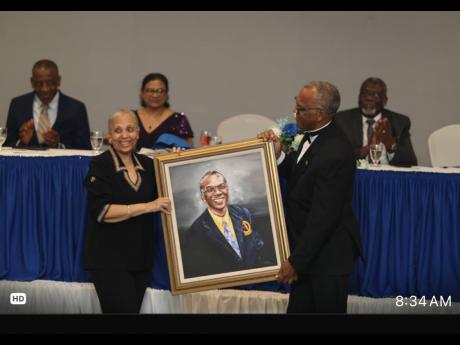 Dr Shobha Chabria-Morant (left) presents Dr Derek Harvey with a portrait of himself, which was painted by Dr Christopher Daley.