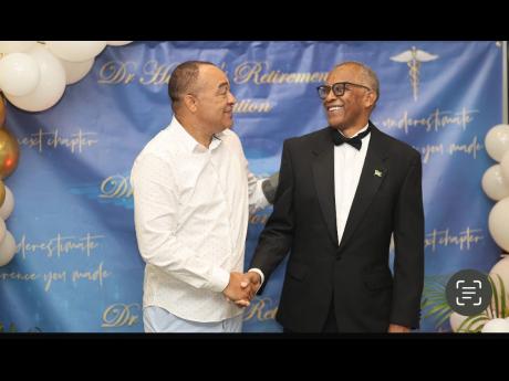 Health and Wellness Minister Dr Christopher Tufton (left) in conversation with Dr Derek Harvey.