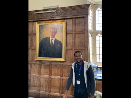 David Salmon in front of the Norman Manley portrait at Jesus College.