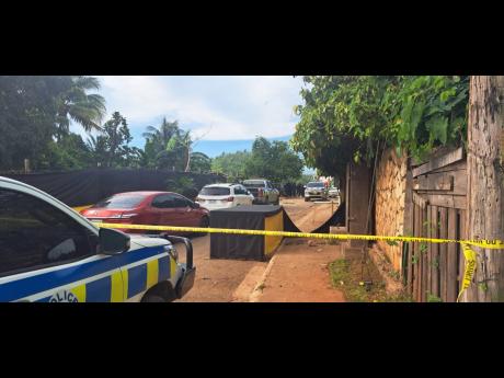 The crime scene set up in the vicinity of yesterday’s shooting in the Tryall Heights, St Catherine area, which left three dead. 