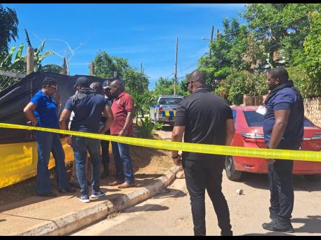 Police carrying out their investigations at the scene of a shoot-out in Tryall Heights, St Catherine.