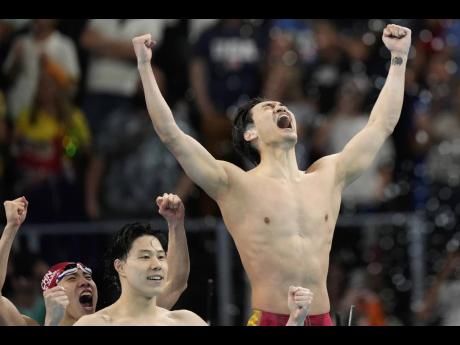 China’s swim team celebrates after capturing the gold medal in the men’s 4x100m medley relay final at the 2024 Olympics in Paris, France, yesterday. 