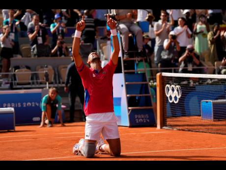 Serbia’s Novak Djokovic reacts after defeating Spain’s Carlos Alcaraz in the men’s singles tennis final at the Roland Garros stadium during the 2024 Summer Olympics in Paris, yesterday.