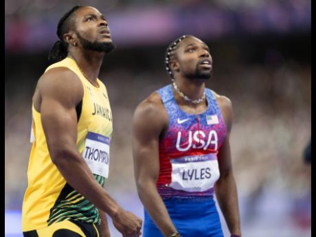 1. Kishane Thomspon (left) of Jamaica and Noah Lyles of the United States look on for the results of the men’s 100m finals at the Stade de France in Paris, France, yesterday. 