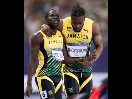 Kishane Thompson (right) and teammate Oblique Seville of Jamaica moments after the men’s 100m finals. 