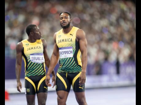 Obligue Seville (left) and teammate Kishane Thompson moments after the men’s 100m final at the Stade de France in Paris, France, yesterday. Thompson was second while an injured Seville placed eighth. 