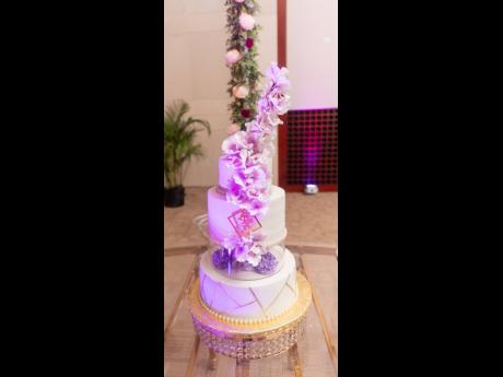 The wedding cake, baked by the bride’s aunt, Paulette Christie, featured three tiers: a traditional fruit cake on the first tier, Baileys Black Forest on the second, and a lemon cake on top.