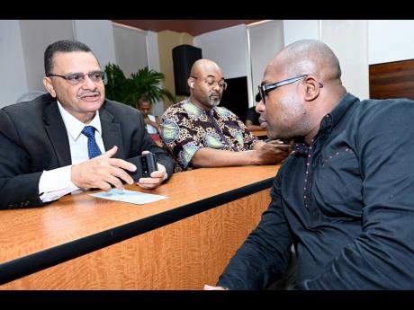 Attorney General Dr Derrick McKoy speaks with Professor Densil Williams, principal and pro-vice chancellor of The University of the West Indies Mona during ‘A Reasoning about Reform of the Jamaica Constitution’ with former Prime Minister Bruce Golding 