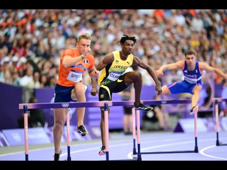 Roshawn Clarke of Jamaica leads the way in heat 4 of the men’s 400m hurdles at the Stade de France in Paris yesterday. Clarke won the heat in 48.17 seconds.