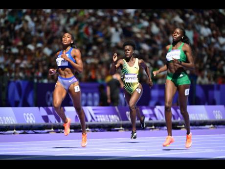 Junelle Bromfield (centre) of Jamaica taking third spot in heat 6 of the  women’s 400m  at the Stade de France in Paris, France, yesterday. Bromfield clocked 51.36 seconds. The heat was won by Rhasidat Adeleke (right) of Ireland in 50.09. At left is Amer