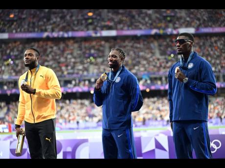 Medallists in the men’s 100m (from left)  Jamaica’s Kishane Thompson (silver),  American Noah Lyles (gold) and his teammate Fred Kerley (bronze) at the medal ceremony inside the Stade de France in Paris, France, yesterday.