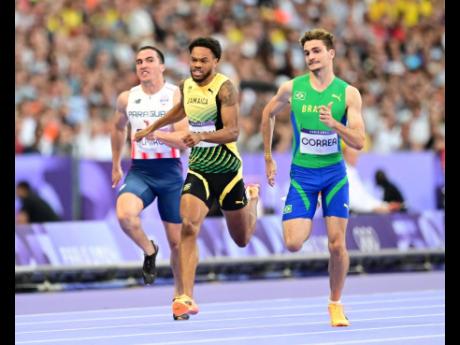 Jamaica’s Andrew Hudson (centre) competing in the men’s 200 metres heat 2 at the Stade de France in Paris, France, yesterday. Hudson placed fourth in 20.53 seconds and did not qualify automatically for the semifinals. He will compete in the 200m repech