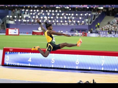 Wayne Pinnock launches himself during his silver-medal-winning run in the men’s long jump at the Stade de France yesterday.