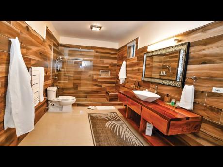 Bathrooms are fitted with rarely seen, polished wood basin counters.