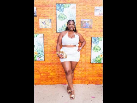  Registered Nurse Shaniek Reid captivated in a white rose slinky halter top and miniskirt set from Pretty Little Thing. 