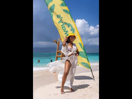 Shanelle James Harris, host of the ‘Savour the City’ food vlog, strikes a pose as the cool Caribbean breeze sweeps over her at Maiden Cay.   