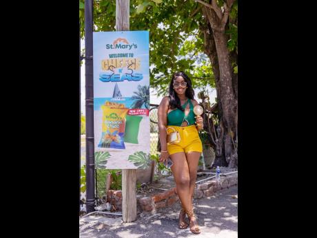 Ashanique Salmon finds a spot in the shade as she waits to board the Loose Cannon catamaran at the Grand Excelsior Hotel.