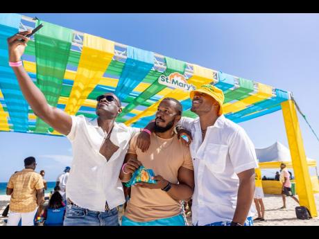 Jermaine Scott-Brandon Watson, more popularly known as ‘Scottycuss’, pulls his friends, Ralston Small (centre), software engineer, and Akeem Boothe, realtor and creator of Moments by Boothe, for a photo.