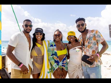  St. Mary’s Tropical Snacks Brand Manager Candise Bulli (second right) shares a moment on the beach with (from left) Karl Brown, Chante Blackwood, Jelaine Phoenix and Joel Youngsang.   