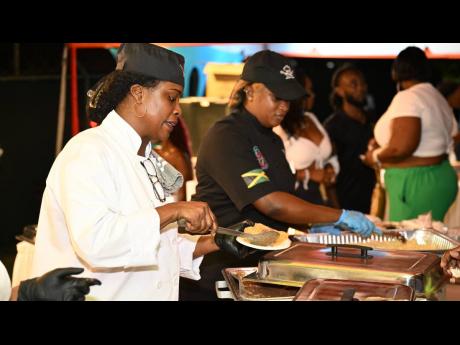 Chef Vanessa Foreman (left) and her business partner Sadia Williams (right) serve up a storm of delicacies which was loved by the locals at the prime minister’s fete in Barbados.  