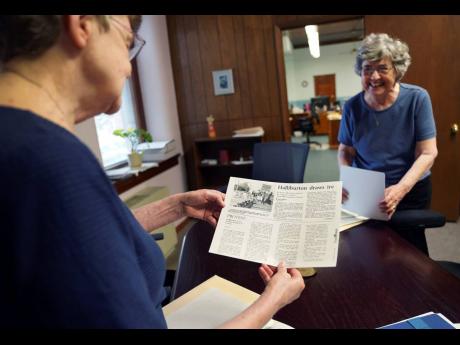 
Benedictine sisters, Rose Marie Stallbaumer, left, and Barbara McCracken, right, look through corporate resolution archives and newspaper clippings at the Mount St Scholastica Benedictine monastery in Atchison, Kansas, on Tuesday, July 16, 2024.