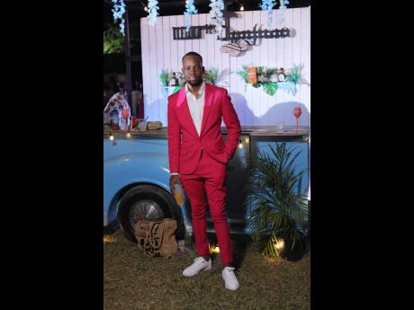 Lasana Wilson stood out at Milk and Honey in a bold hot pink suit, paired with a classic white button-down a nd matching white kicks.