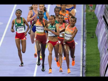 Faith Kipyegon, of Kenya,, right, fights for the lead with Gudaf Tsegay, of Ethiopia, during the women’s 5000 meters final at the 2024 Summer Olympics, in Saint-Denis, France.