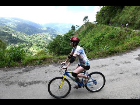 In this 2018 photo, a tourist is seen riding a bicycle in the Blue and John Crow Mountains National Park. 