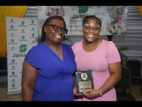 Michelle McCalla (left) congratulates her daughter, Jade McCalla, second-year finance student at Northern Caribbean University with a grade point average of 3.87 for being the Jamalco top awardee at this years scholarship awards ceremony.