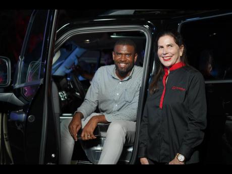 Testing the tank life, Ian Bourne, branch manager at Sagicor Life Jamaica, is joined by managing director of Stewart’s Auto Sales Limited, Jacqueline Stewart Lechler.