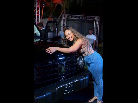 Attorney-at-Law Ariel von Cork, who bought a Tank 300, is all smiles cosying up to the vehicle on display, as she awaits the big day when her new car arrives.  