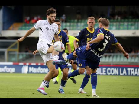 Napoli’s Khvicha Kvaratskhelia (left) and Hellas Verona’s Martin Frese in action during a Serie A match yesterday at the Marcantonio Bentegodi Stadium in Verona. 