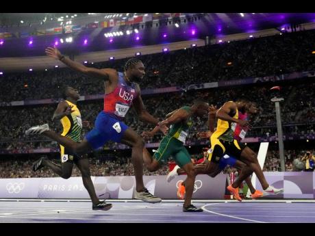 Noah Lyles, of the United States, second left, celebrates as he wins the men’s 100-metre final ahead of Kishane Thompson, of Jamaica, at the 2024 Summer Olympics in Saint-Denis, France. (