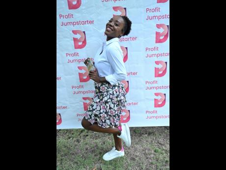 BELOW: Heneka Watkis-Porter is chic and playful in a floral skirt, white shirt and complementary low tops.