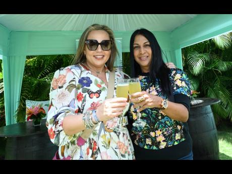 Our cameras captured the gracious Dominique Silvera (left) and Raquel Dadlani of The Pinnacle raising a toast to the event’s activities.