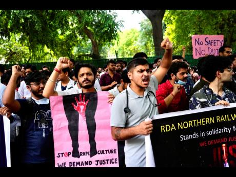 Doctors and paramedics protesting against the rape and killing of a trainee doctor at a government hospital in Kolkata gather in front of the Indian health minister’s office in New Delhi, India, on Monday.  