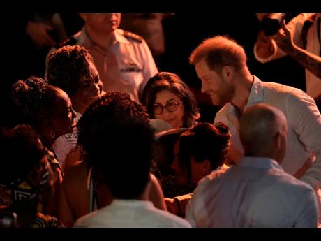 Prince Harry greets people during a forum on Afro women and power in Cali, Colombia on Sunday.