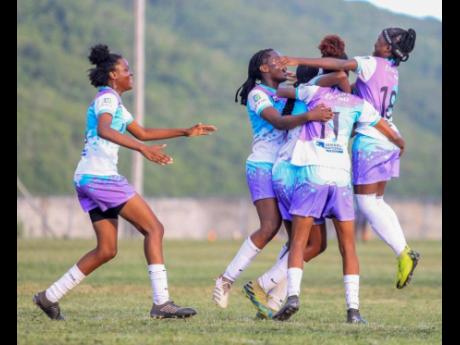 Reinas Academy players celebrate after scoring against Kingston Football Academy in the Reinas Cup under-20 women’s final at the  UWI Bowl last year.  Reinas defeated Kingston Football Academy 2-0. 