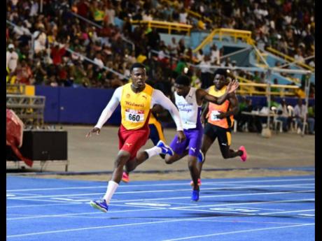 Gary Card looks at the clock after winning the under-20 boys’ 100 metres at the JAAA/PUMA National Junior and Senior Championships inside the National Stadium in June.