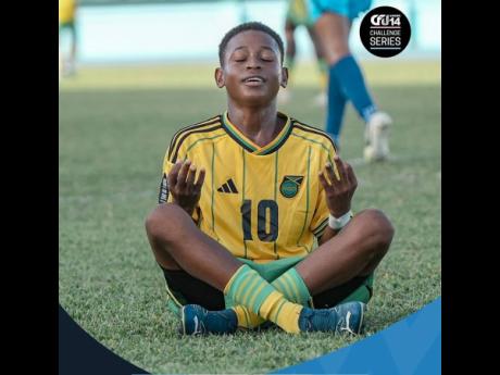 Jamaica’s Davion Clarke finds a unique way to celebrate during Jamaica’s 5-0 win over Aruba in the Caribbean Football Union Under-14 Challenge Series at the Dwight Yorke Stadium in Trinidad and Tobago yesterday.