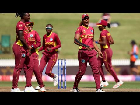 Hayley Matthews (right) of the West Indies celebrates after taking the wicket of Deepti Sharma of India during the 2022 ICC Women’s Cricket World Cup match against India at Seddon Park on March 12, 2022 in Hamilton, New Zealand.