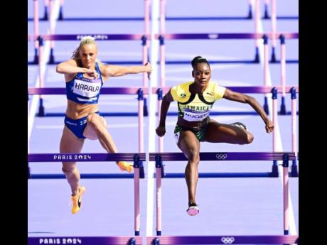 Ackera Nugent (right) of Jamaica competing in heat 5 of the women’s 100m hurdles round one at the Paris Olympics inside the Stade de France on August 7.