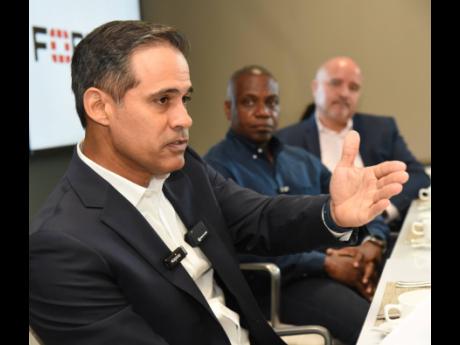 Carlo Caloca (left), regional sales manager, Fortinet English Caribbean, presents the latest findings from FortiGuard labs, highlighting that cybercriminals are exploiting vulnerabilities 43 per cent faster, The role of artificial intelligence in cybersecu