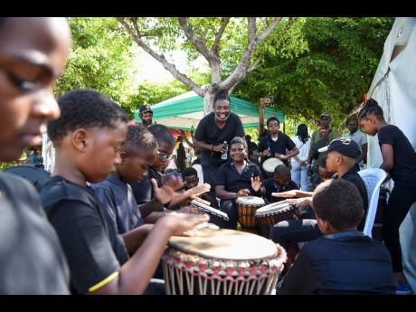 Students of St Andrew Preparatory Drumming Ensemble with their music teacher, Ricardo Nicholas, at Institute of Jamaica’s Africa Day Exhibition, celebrated on May 25 at the St William Grant Park in Kingston.