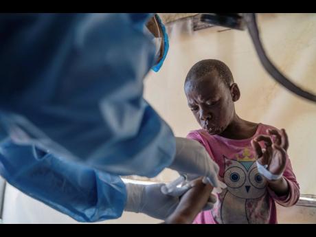 A health worker attends to an mpox patient, at a treatment centre in Munigi, eastern Congo.