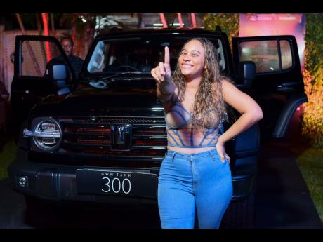 Ariel von Cork is a picture of joy as she strikes a pose beside the GWM Tank 300 at the official
launch event. She is one of the first owners of the new vehicle.