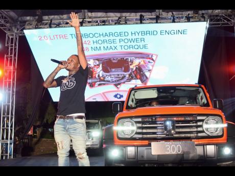 
With the striking orange GWM Tank 300 as his backdrop, dancehall artiste Valiant delivers an energetic performance during the launch event.