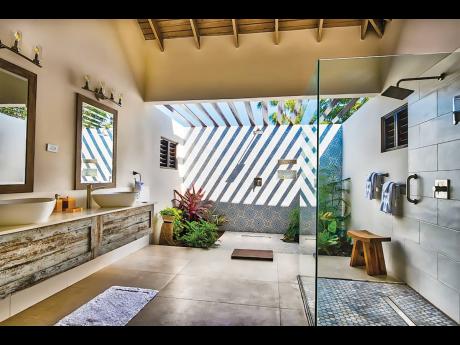  A true, tropical bathroom with both indoor and outdoor showers, and a double basin vanity.