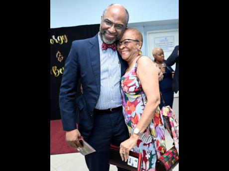 Earl Jarrett (left), chairman and chief executive officer of the Jamaica National Group, warmly greets Gene Douglas, honorary board member of the National Chorale of Jamaica.