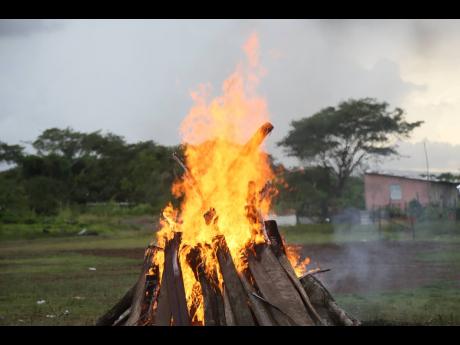 The bonfire lit at the memorial in Cherry Tree Lane, Four Paths, Clarendon last Friday.